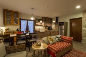 a living room with a couch and a kitchen at Casa de Campo Sossego da Lata in Fafe