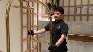 a man is holding onto a gold door at Vivian Park Residential Apartment in Riyadh