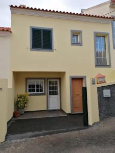 a house with a front door and a door at Despertar do Sol in Santa Cruz