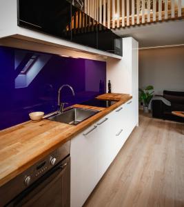 a kitchen with a sink and a counter top at Nyrenovert leiliget 1 min unna solsiden in Trondheim