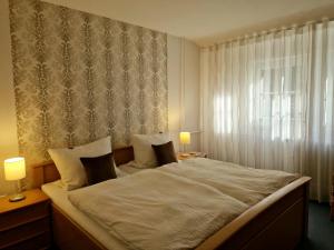 a bedroom with a large bed and a window at Ferienwohnungen Tannenhof in Willingen