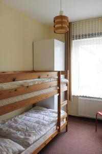 a bedroom with two bunk beds and a window at Haus Strandgang, Whg 8 in Kellenhusen