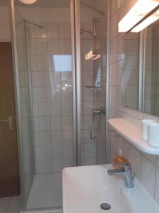 a bathroom with a shower and a sink at Haus Strandgang, Whg 5 in Kellenhusen