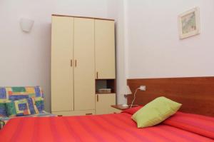 a bedroom with a bed with a large cabinet at Hotel Villa Argentina in Riomaggiore
