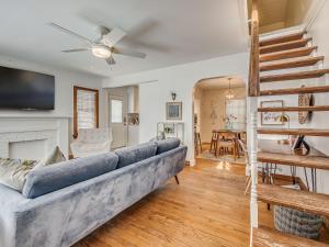 a living room with a blue couch and a fireplace at The Charming Pecan Place! in Oklahoma City