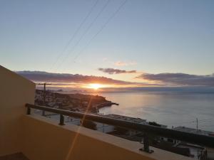 a sunset from the balcony of a building at Despertar do Sol in Santa Cruz