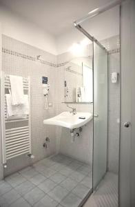 a bathroom with a sink and a shower at Hotel Villa Argentina in Riomaggiore