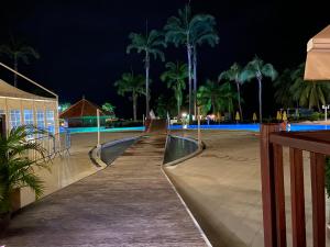 a boardwalk leading to the beach at night at Studio RDC La Désirade Martinique accès direct plage in Sainte-Luce