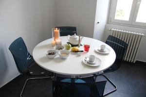 a white table with bowls of food on it at Ex Dogana Home in Fiumicino