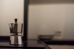 a glass container with a candle on a table at Splendido appartamento nel centro di Roma, Monti in Rome +59 photos