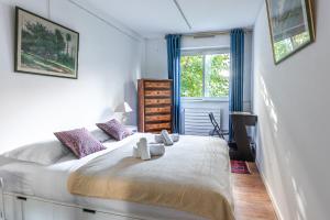 - une chambre avec un grand lit blanc et des rideaux bleus dans l'établissement Amazing Apartment - 6 guests - 5 min from Gare de Lyon, à Paris