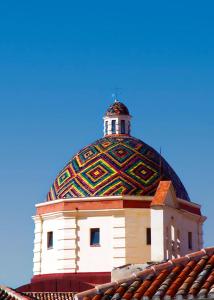 a building with a colorful dome on top of it at Home Feeling Mascagni - Bilocale in Alghero