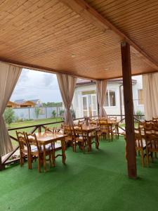 a group of tables and chairs under a pavilion at Solomon in Alakhadzi