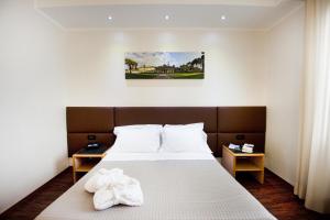 Postel nebo postele na pokoji v ubytování Hotel Minerva