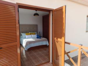 a bedroom with a bed and a sliding glass door at Vista Volcán in Lajares