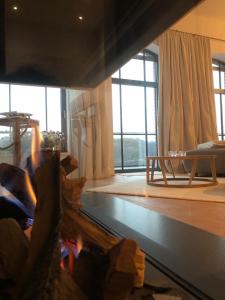 a person sitting on a couch in a living room at Loft mit Seeblick in Malchow