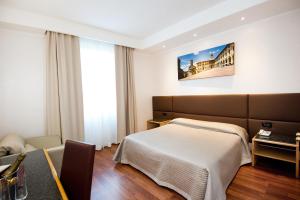 Postel nebo postele na pokoji v ubytování Hotel Minerva