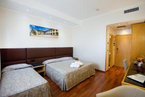 Postel nebo postele na pokoji v ubytování Hotel Minerva