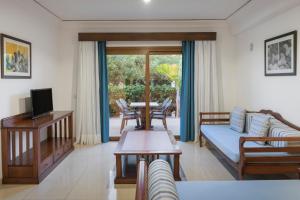 a living room with a couch and a table at Marylanza Suites & Spa in Playa de las Americas