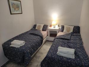 a room with two beds and a table with a lamp at Aldea del Mar in Torrevieja +30 photos