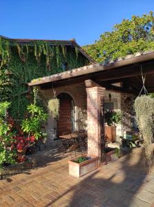 a brick house with a patio with plants at Sole Mio in Velletri