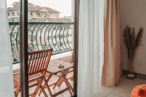 a balcony with a chair and a table on a balcony at Gee homestay in Kota Kinabalu