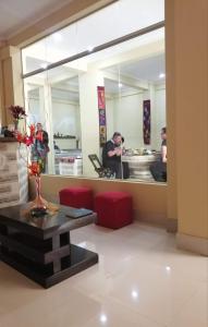 Hotel REY DAVID في أويوني: غرفة معيشة مع مرآة كبيرة وطاولة