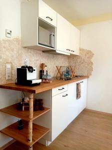 a kitchen with white cabinets and a counter with a microwave at FeWo Tulipa Vera mit traumhafter Aussicht in Todtmoos
