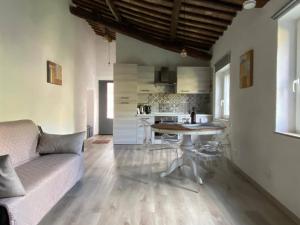 a living room with a couch and a table at Casa Biscarello - Borgo e Lago in Grotte di Castro +23 photos