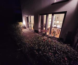 a group of chairs sitting outside of a building at night at Komfortable Ferienwohnung Auf dem Höchsten in Dortmund