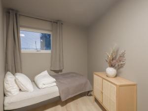 a small bedroom with a bed and a window at Staying Apt 1 - New and modern in Tromsø