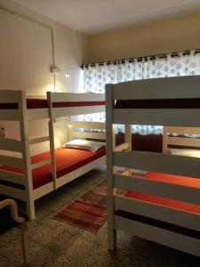 a bedroom with two bunk beds and a window at Raahgir in Nashik