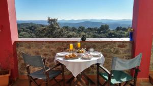 a table with a plate of food on a balcony at Hotel La Era de Aracena - Adults Only in Aracena