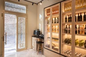 a wine tasting room with a wall of wine bottles at Epoch House & The Orange Shop - Adults Only in Nafplio