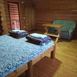 a room with two beds and a table and a couch at "У вуйка" in Uzhhorod