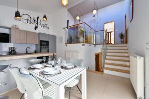 a kitchen and dining room with a white table and chairs at Holiday Home Hanna Toplice Sveti Martin in Sveti Martin na Muri