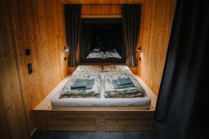 a bedroom with two beds in a wooden room at Baumwipfel-Resort "Lug ins Land" in Ilsenburg