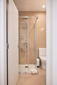 a shower with a glass door in a bathroom at Refugio in Porto