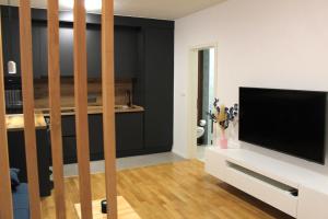 a living room with a flat screen tv on a white cabinet at Apartmani Paula 