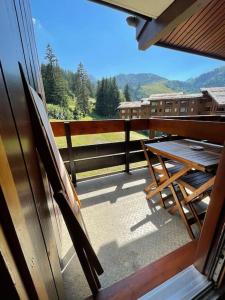 a view from a window of a balcony with a table at Le cheval noir 37 (6-7 couchages ) in Valmorel