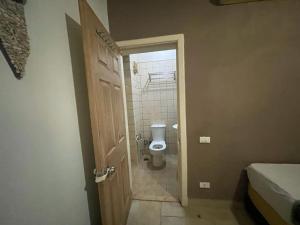 a bathroom with a toilet and an open door at 2 bed 2 bath,pool facility,roof top with sea view in Sharm El Sheikh