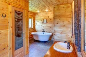 a wooden bathroom with a tub and a sink at Bull Run Ranch in Margaretville