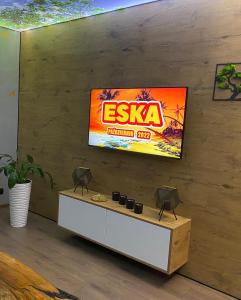 a television on a wall in a living room at Apartament ARKANA PREMIUM in Świętochłowice