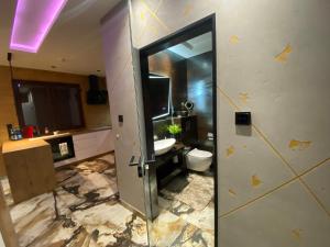 a bathroom with a sink and a toilet in a room at Apartament ARKANA PREMIUM in Świętochłowice +2 photos