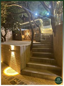 a set of stairs with a tree on top at AlSalti Farm - مزرعة السلطي in Ajloun