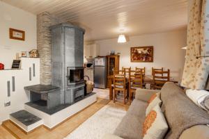 a living room with a fireplace and a dining room at Chaty Daniela in Liptovský Ján