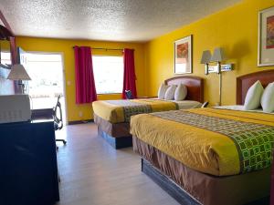 pokój hotelowy z 2 łóżkami i żółtymi ścianami w obiekcie Morning Star Inn w mieście Anson