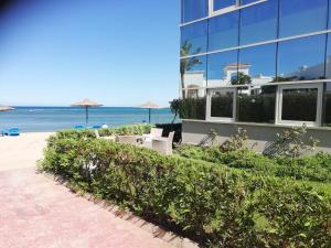 a building on the beach next to the ocean at Cecelia resort in Hurghada