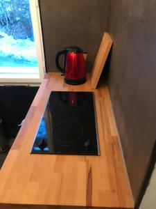 a tea kettle sitting on top of a wooden table at Apartment 26 Eighty in Semmering