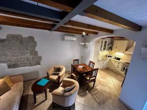 a large living room with a table and chairs at Beautifully Restored 400-year Old House with Stunning Sea Views from the Terrace in Dubrovnik